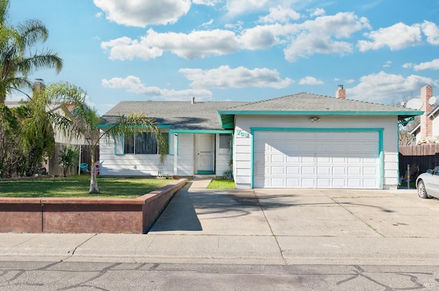 ranch-style home featuring a garage and a front lawn