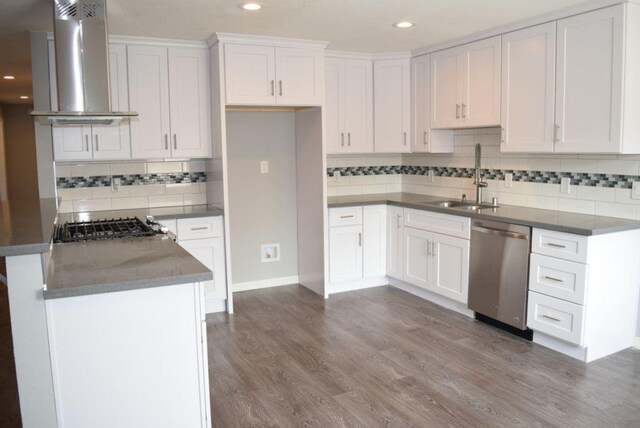 kitchen with white cabinets, stainless steel appliances, wall chimney exhaust hood, and sink