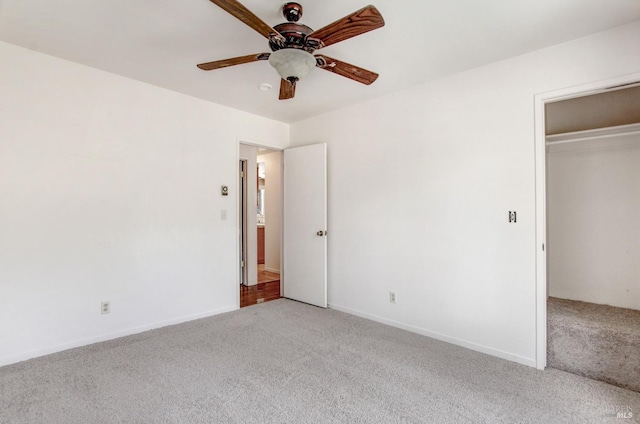 unfurnished bedroom featuring a ceiling fan, baseboards, a closet, and light colored carpet