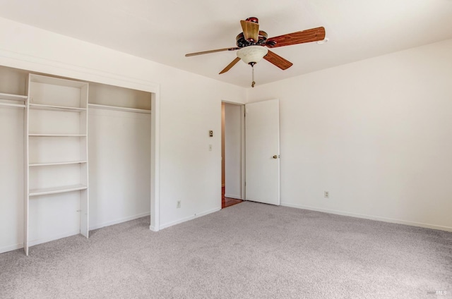 unfurnished bedroom featuring a ceiling fan, a closet, light colored carpet, and baseboards