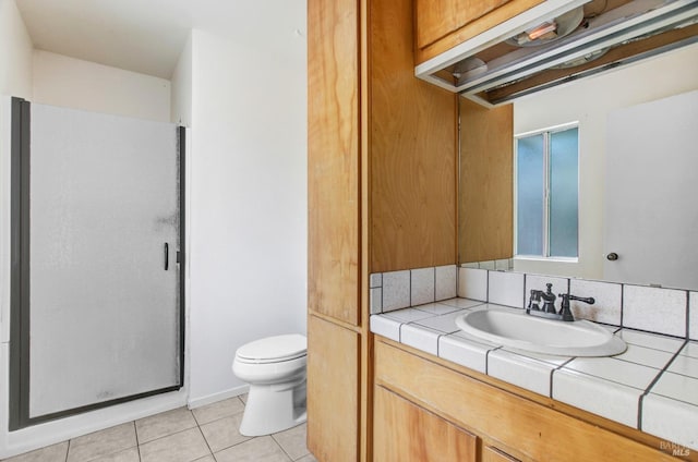 full bath with a shower stall, vanity, toilet, and tile patterned floors