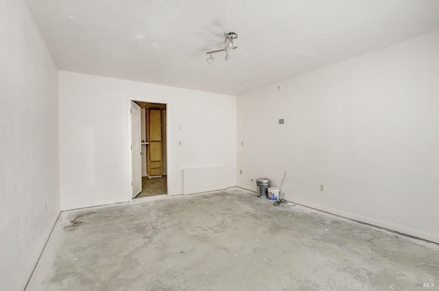 unfurnished room featuring unfinished concrete floors