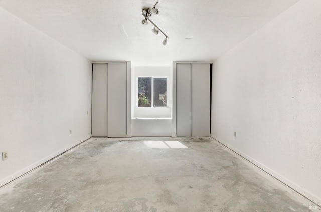 spare room with unfinished concrete floors