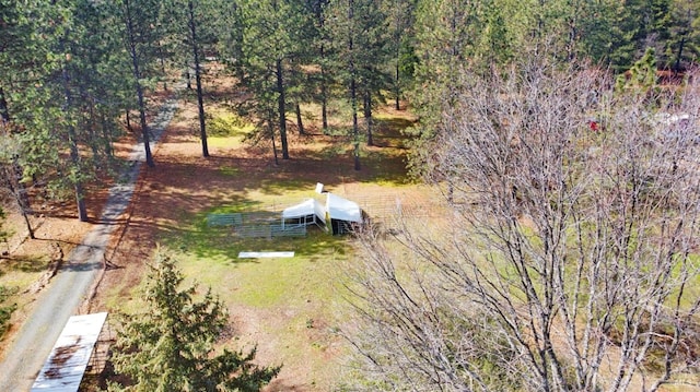 drone / aerial view featuring a forest view