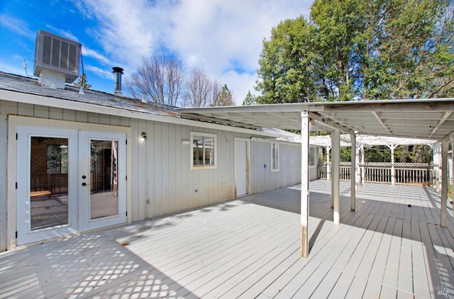 deck featuring french doors, central AC unit, and fence