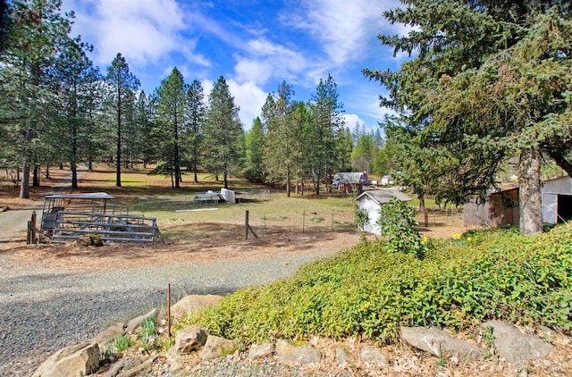 view of yard with an outdoor structure and fence