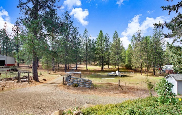 view of community featuring an outdoor structure and fence