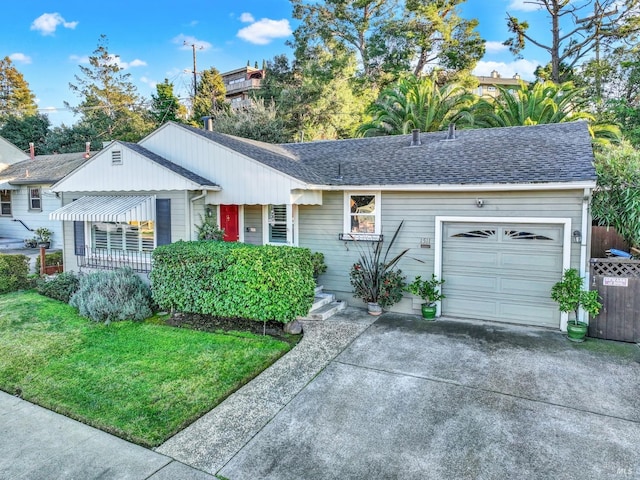 ranch-style house featuring a garage and a front lawn