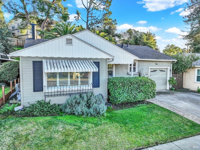 view of front of home with a garage and a front lawn