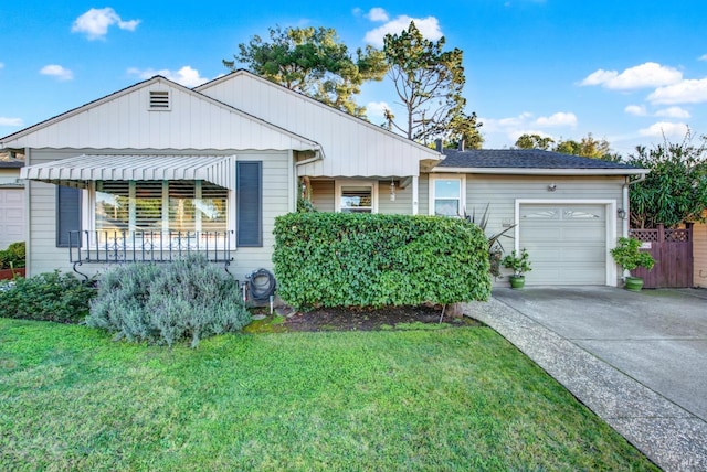 single story home featuring a front lawn, a porch, and a garage