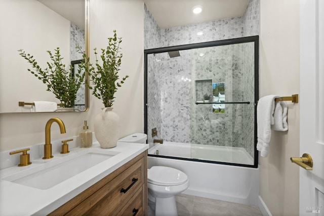 full bathroom featuring vanity, shower / bath combination with glass door, and toilet