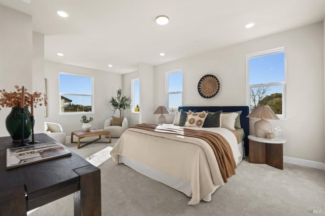 bedroom featuring multiple windows and light colored carpet