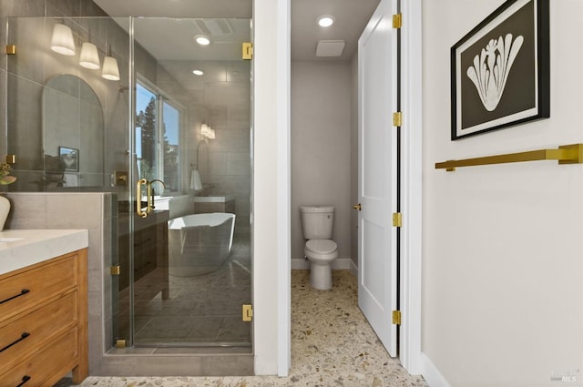 bathroom featuring vanity, toilet, and a shower with shower door