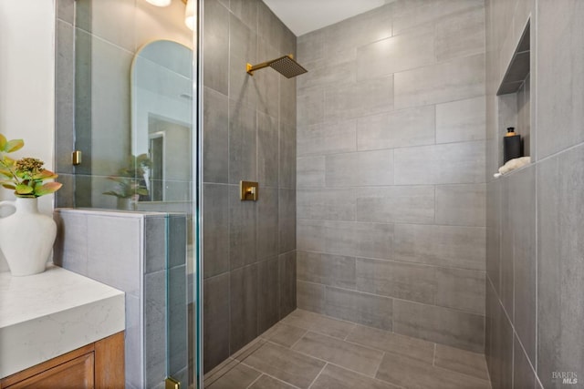 bathroom featuring vanity and a shower with shower door