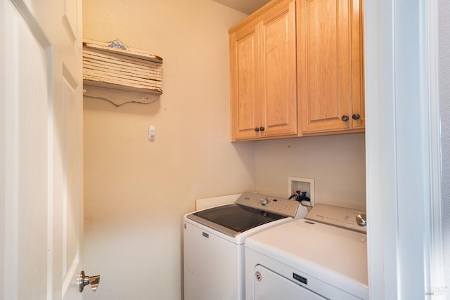 laundry area with cabinets and independent washer and dryer