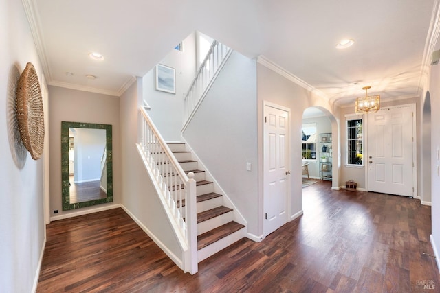 foyer entrance featuring ornamental molding, dark hardwood / wood-style flooring, and a notable chandelier