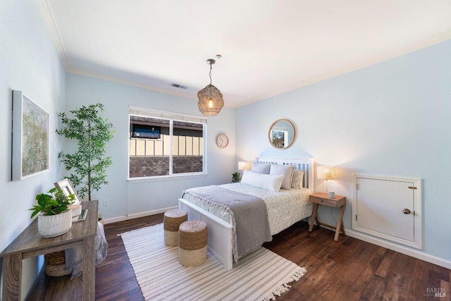 bedroom featuring crown molding and dark wood-type flooring