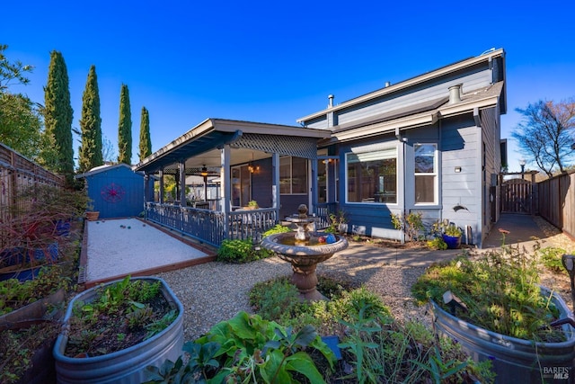 view of front of property featuring a storage shed