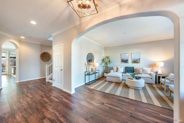 living room with ornamental molding, dark hardwood / wood-style floors, and a notable chandelier