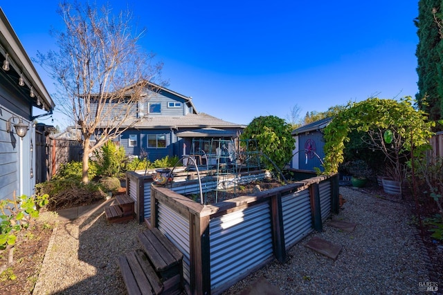 back of property featuring a storage shed