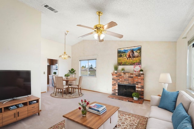 living room with a textured ceiling, ceiling fan with notable chandelier, lofted ceiling, and a brick fireplace