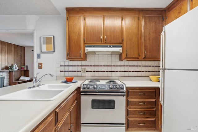 kitchen with backsplash, sink, a textured ceiling, and white appliances