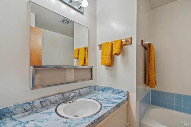 bathroom featuring vanity and a tub to relax in