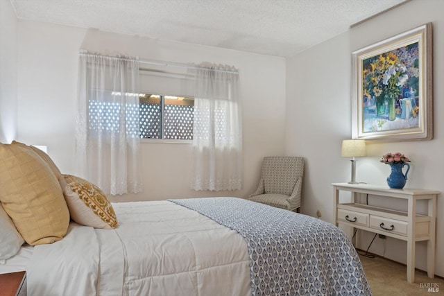 bedroom featuring carpet flooring and a textured ceiling