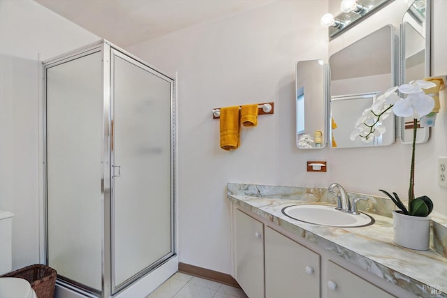 bathroom with vanity, toilet, and an enclosed shower