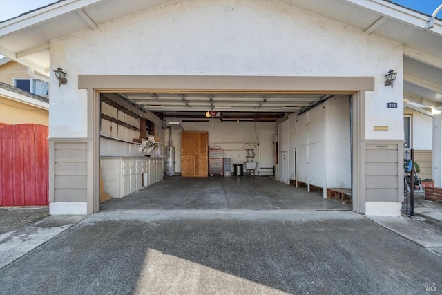 garage with secured water heater and a garage door opener