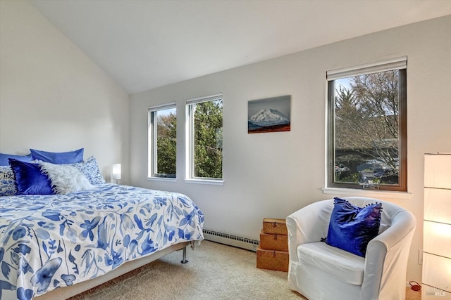 carpeted bedroom with a baseboard heating unit and lofted ceiling