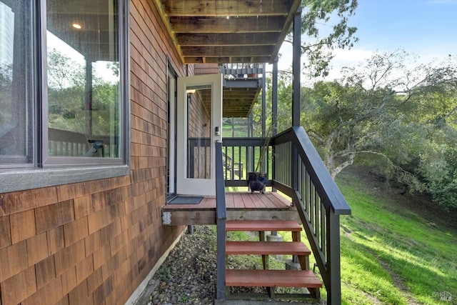 wooden terrace featuring a yard