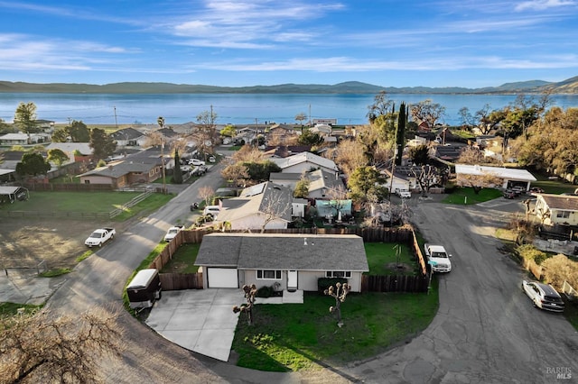 birds eye view of property featuring a water and mountain view