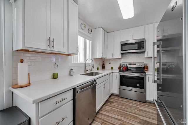 kitchen with white cabinetry, sink, and appliances with stainless steel finishes