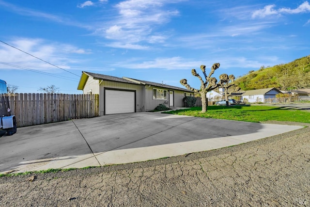 ranch-style house with a front yard and a garage