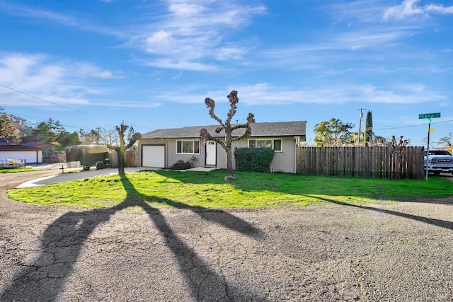 single story home with a front yard and a garage