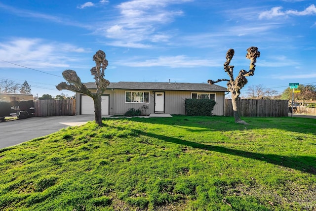 ranch-style home featuring a front yard and a garage