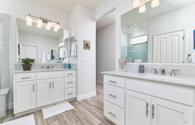 bathroom featuring a shower, vanity, and hardwood / wood-style flooring