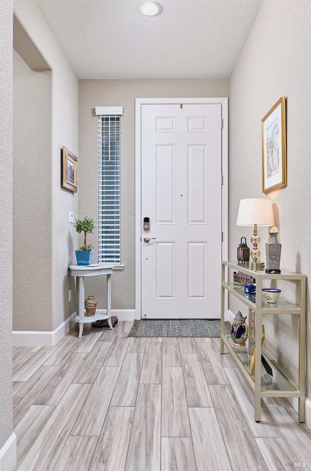 foyer with a textured ceiling