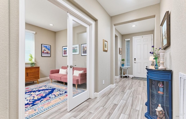 entryway featuring french doors and light hardwood / wood-style floors