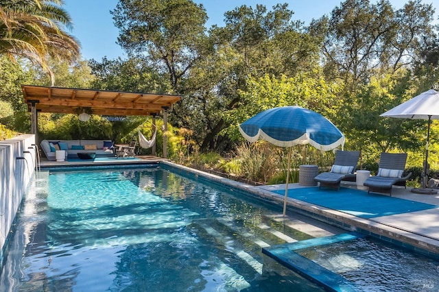 view of pool with outdoor lounge area, a pergola, and a patio