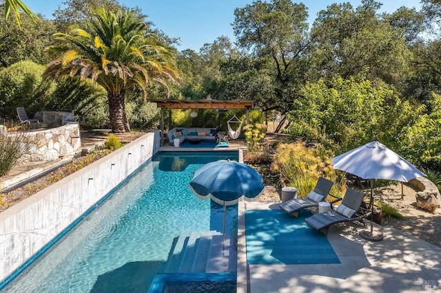 view of swimming pool featuring outdoor lounge area, a pergola, and a patio