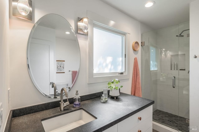 bathroom with vanity and a shower with shower door