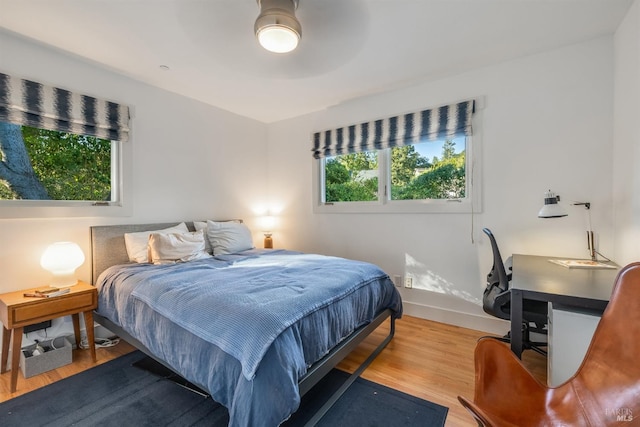 bedroom with light hardwood / wood-style floors and ceiling fan