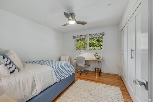 bedroom with a closet, hardwood / wood-style flooring, and ceiling fan