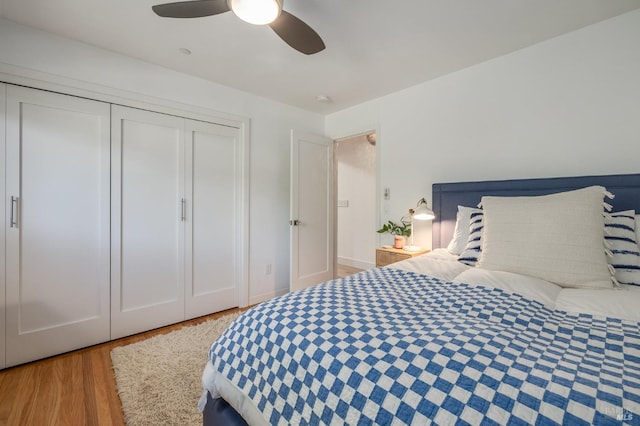 bedroom featuring ceiling fan, light hardwood / wood-style floors, and a closet