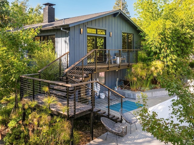 back of property featuring a patio and a deck