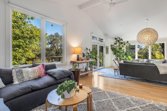 interior space with beamed ceiling, ceiling fan, high vaulted ceiling, and light hardwood / wood-style flooring