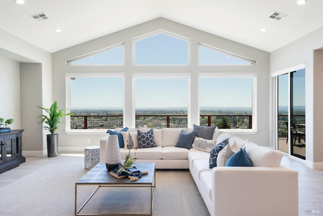 living room with light hardwood / wood-style flooring and vaulted ceiling