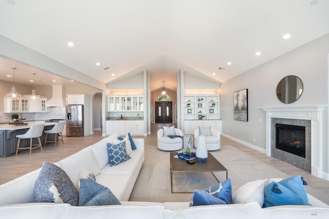 living room featuring light hardwood / wood-style floors and lofted ceiling